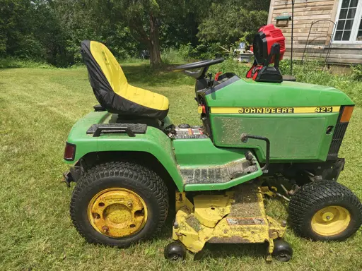 Image depicts a John Deere lawn tractor with a Milwaukee Battery fan on the hood